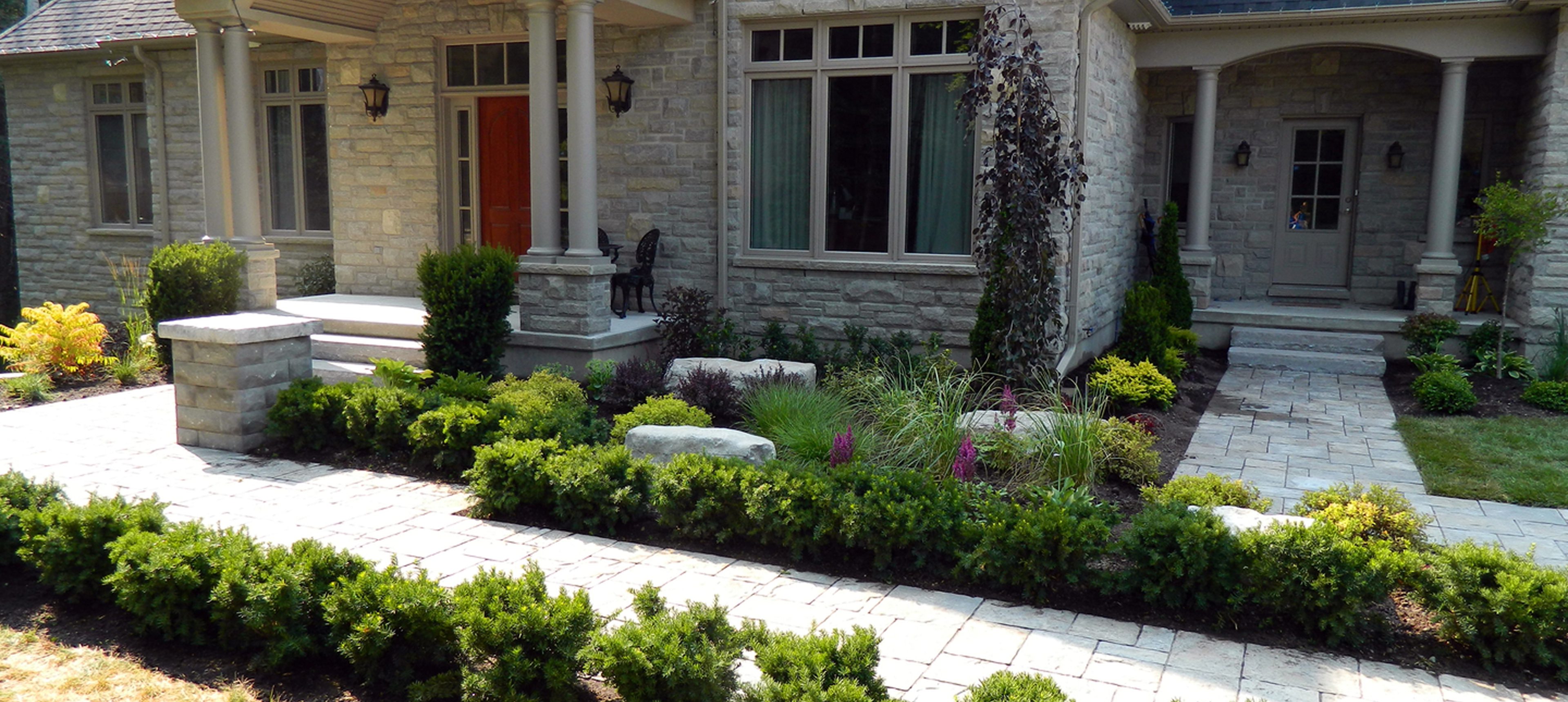 Front porch with greenery and stone path